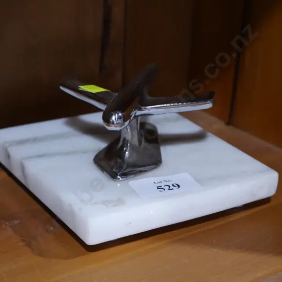 Chrome plane on marble stand