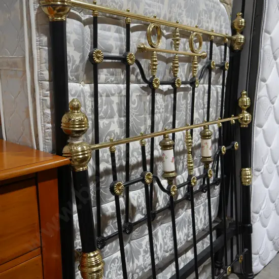 Double bed with wrought iron and a brass bed ends
