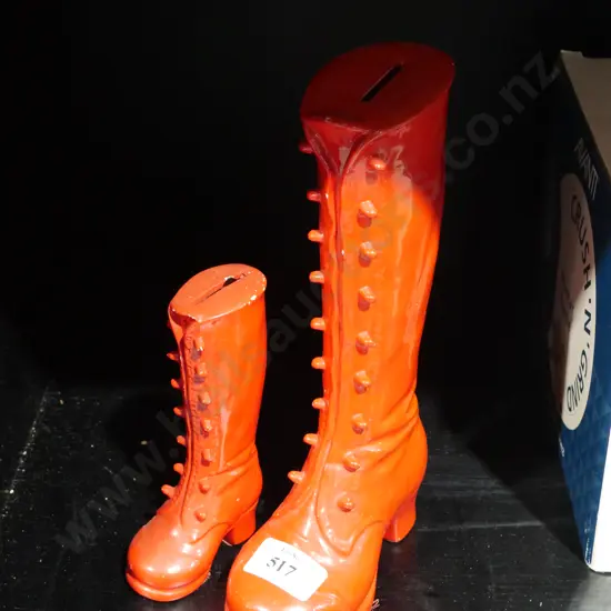 2 red boot money boxes, one full.