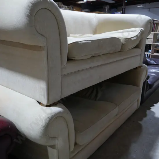 2 cream rolled arm settees