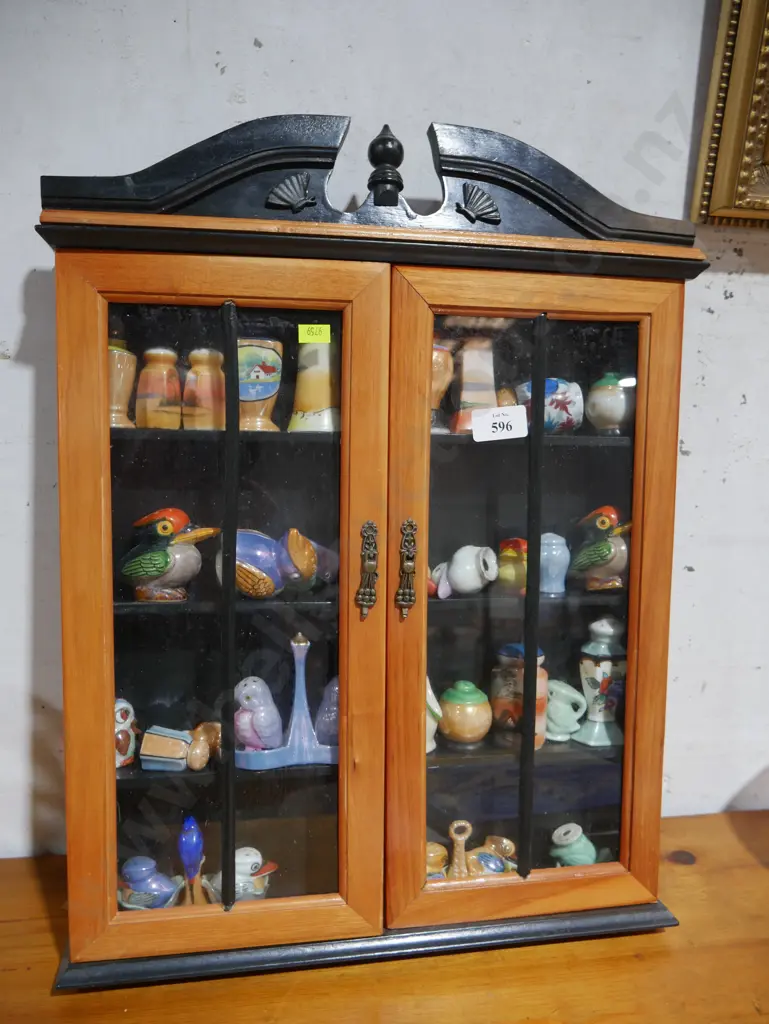 Assorted salt and pepper shakers in display case Image 1++