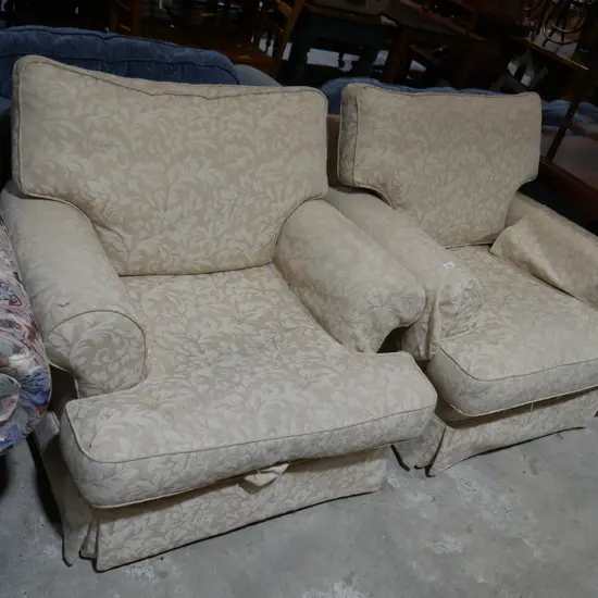 Two cream armchairs