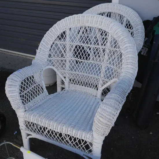 2 white cane chairs