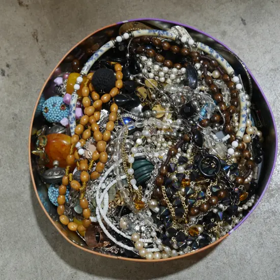 Tin of costume jewellery