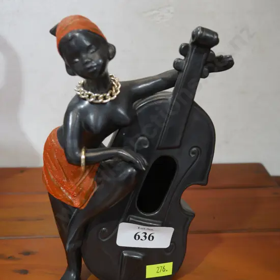 Lady figurine playing instrument