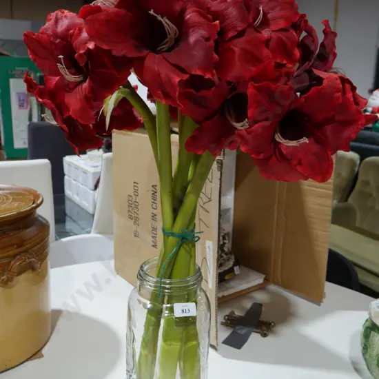 Artificial flowers in glass jar