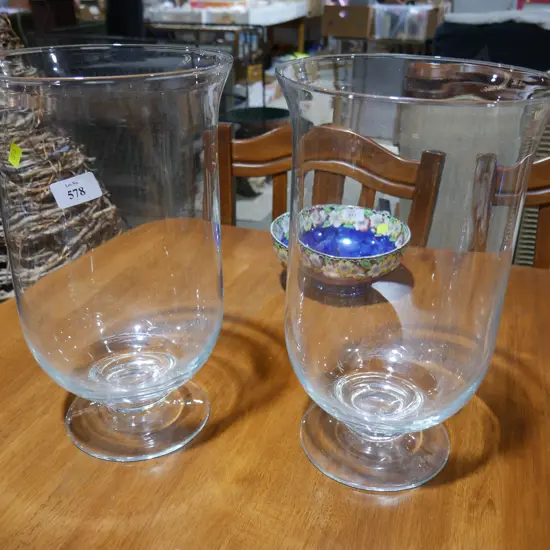 A pair of large glass candle holders