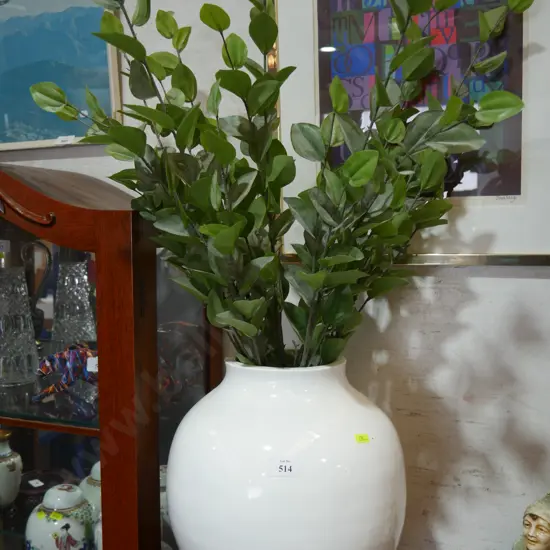 Large white vase with artificial plants