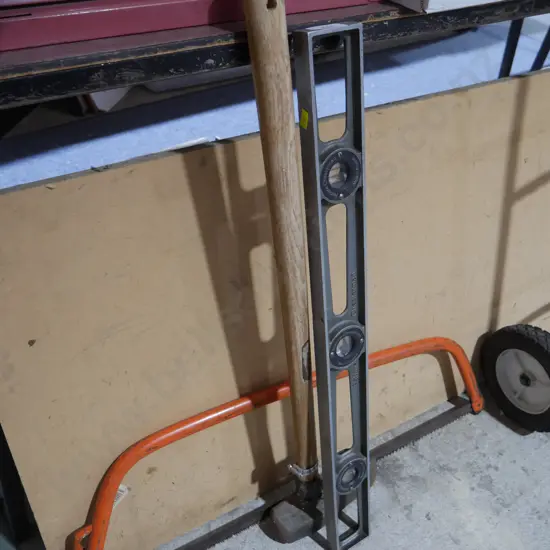 Splitting maul, spirit level, bow saw