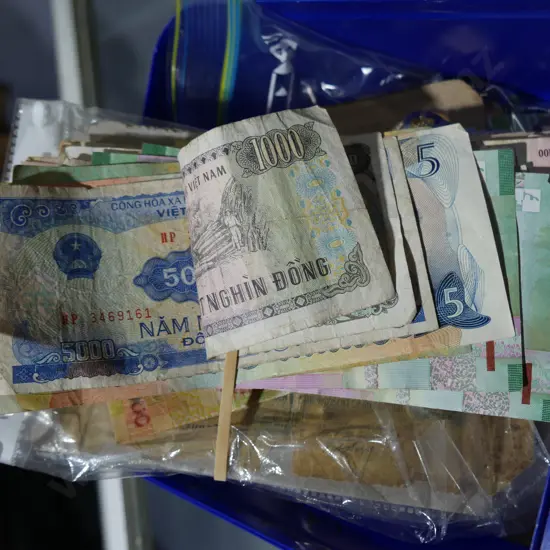 Plastic tub of badges, bank notes, button etc