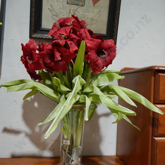 Artificial flowers in glass vase