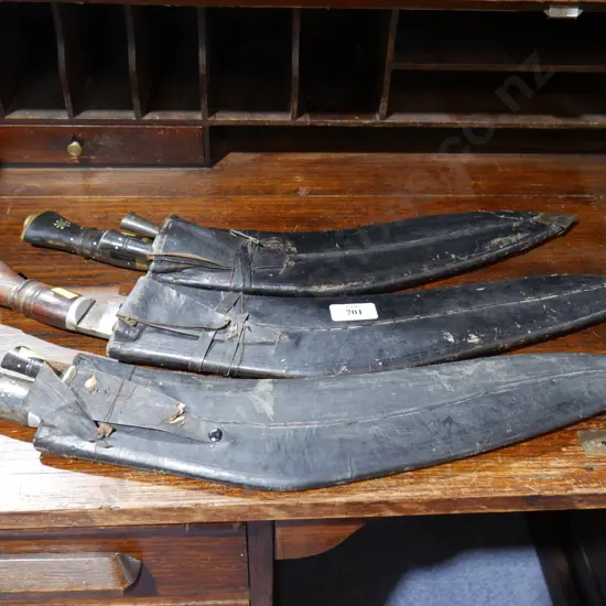 3 kukri knives in leather sheathes