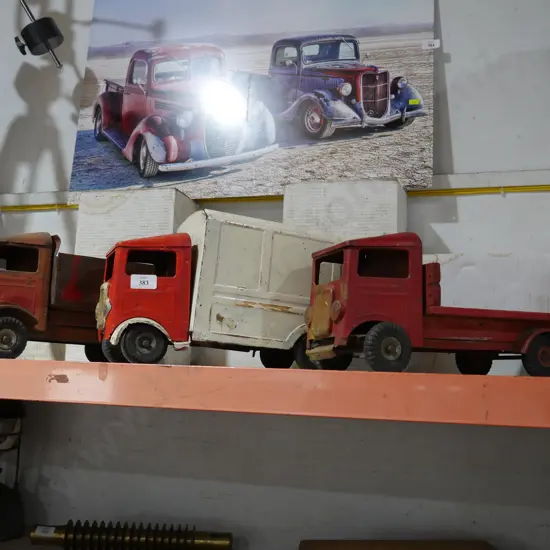 3 tin trucks