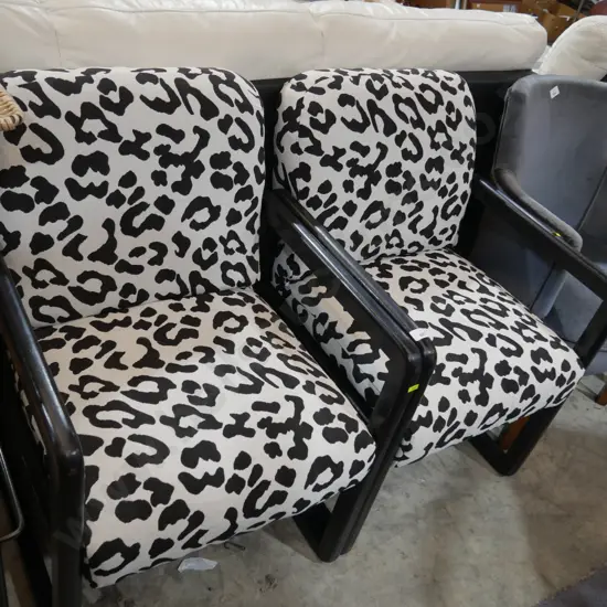 Pair of black and white leopard print armchairs