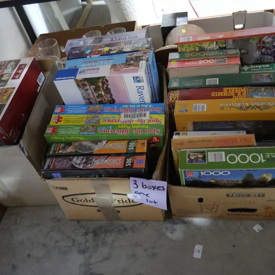 Three boxes of jigsaws
