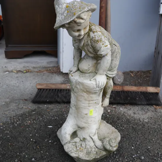 Boy climbing tree trunk garden ornament