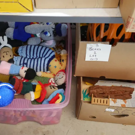 Three boxes of knitted toys, helmets etc