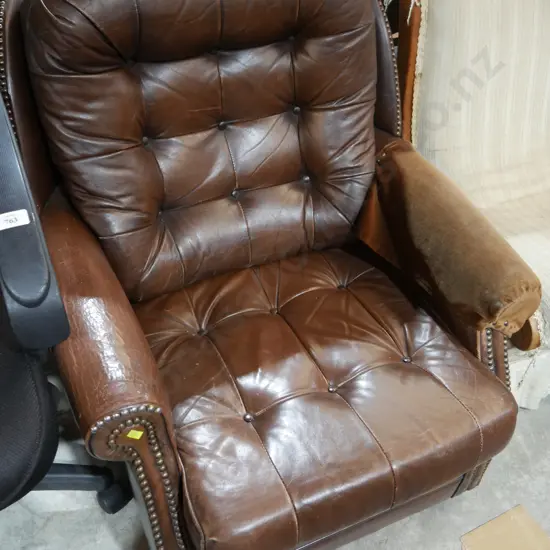 Deep buttoned leather arm chair