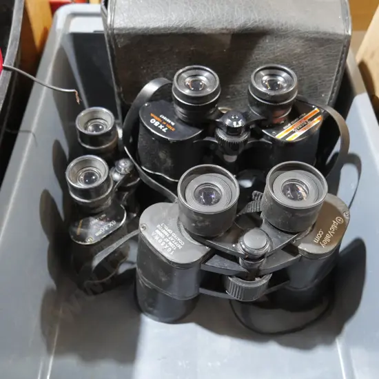 Three pair of binoculars