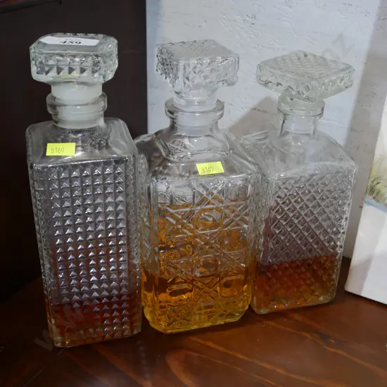 3 decanters and contents