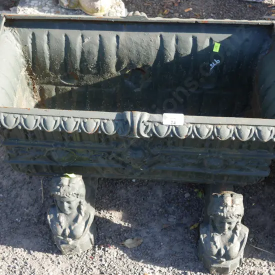 Green cast iron planter with stands