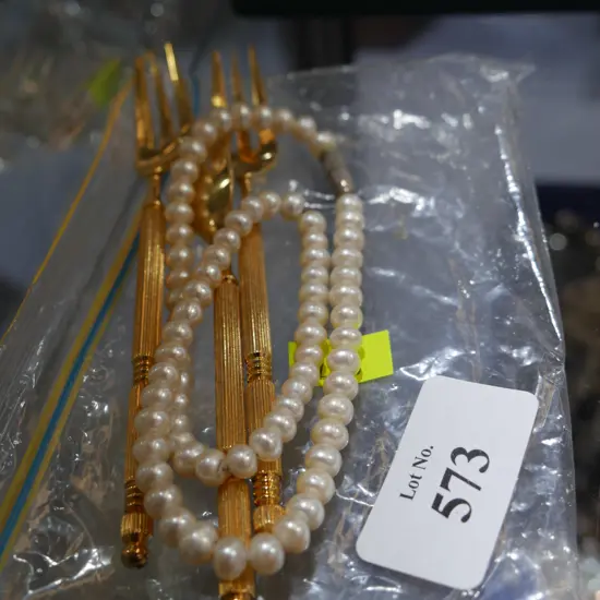 Pearl necklace and 3 cake forks