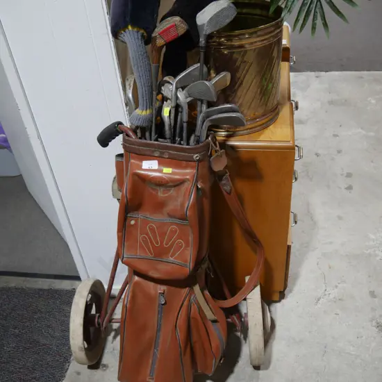 Old golf trundler and golf clubs