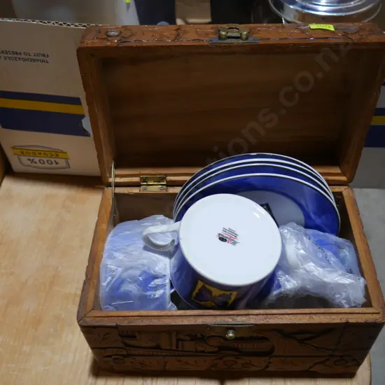 Wooden box with cups and sauces