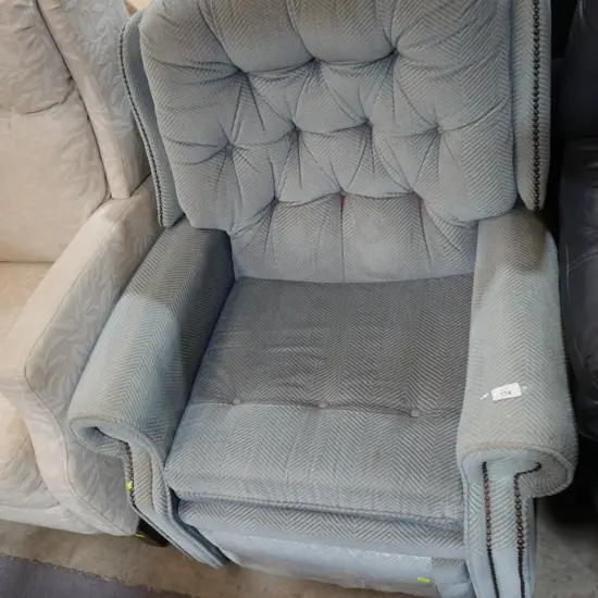 Deep buttoned recliner armchair