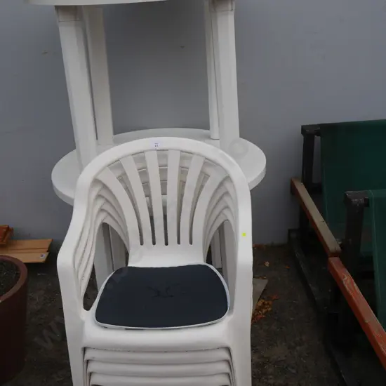 2 plastic tables and four chairs