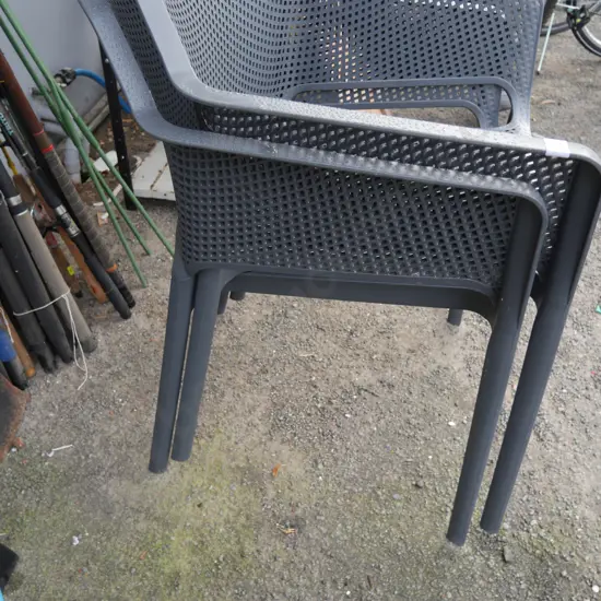 2 grey plastic chairs