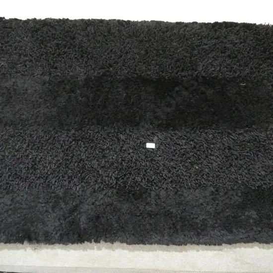 Black shaggy floor rug