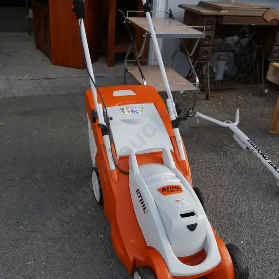 Stihl electric mower, battery and charger in office
