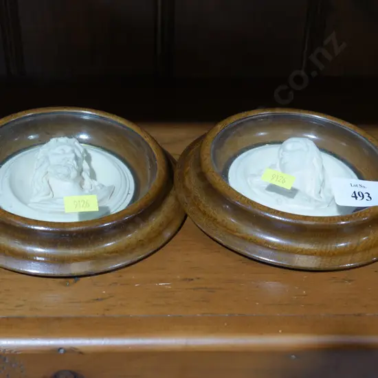 2 wood framed religious figures