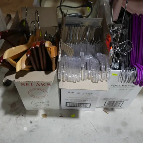 Three boxes of coat hangers