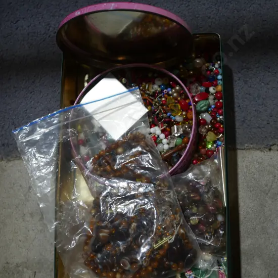 Tin of costume jewellery