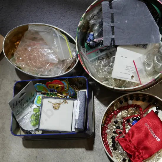 Four tins of costume jewellery