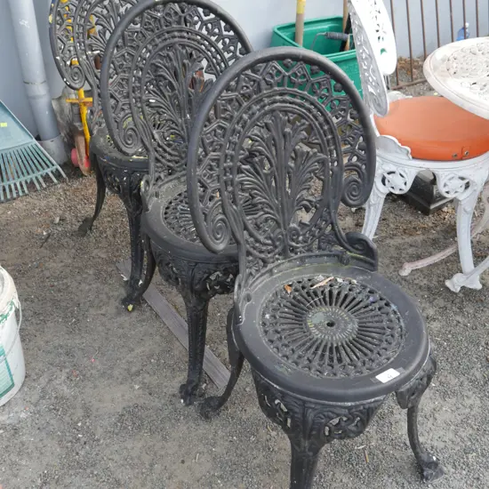 3 black wrought iron chairs