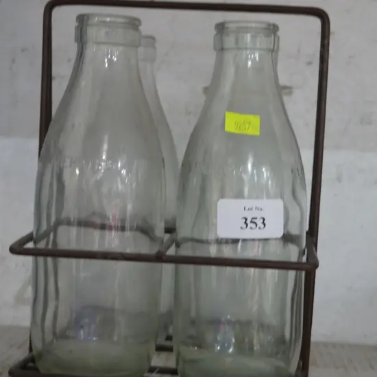 4 glass milk bottles and holder