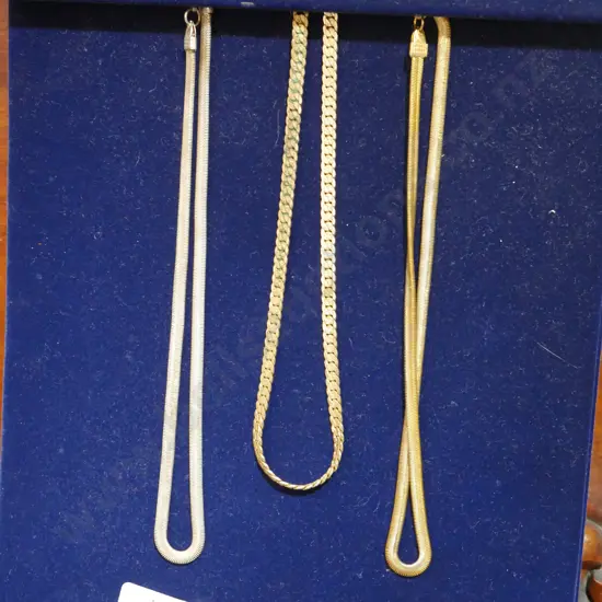 Gold necklaces on stand