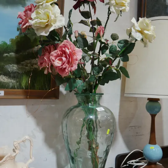 Large glass vase with artificial flowers
